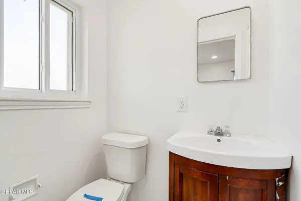 a bathroom with a sink a toilet and mirror