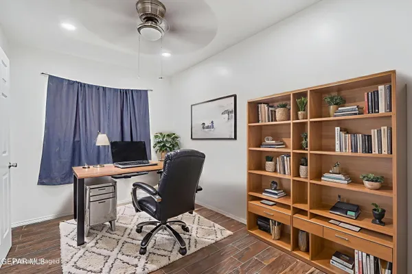 a view of a workspace with furniture and cabinet