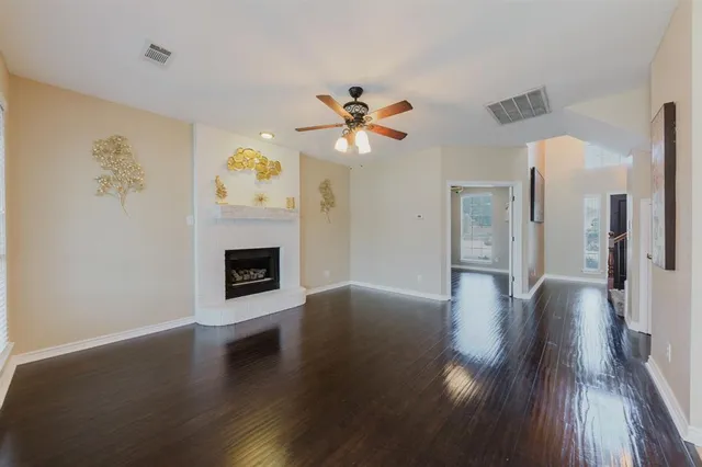 a view of a kitchen with wooden floor and a window