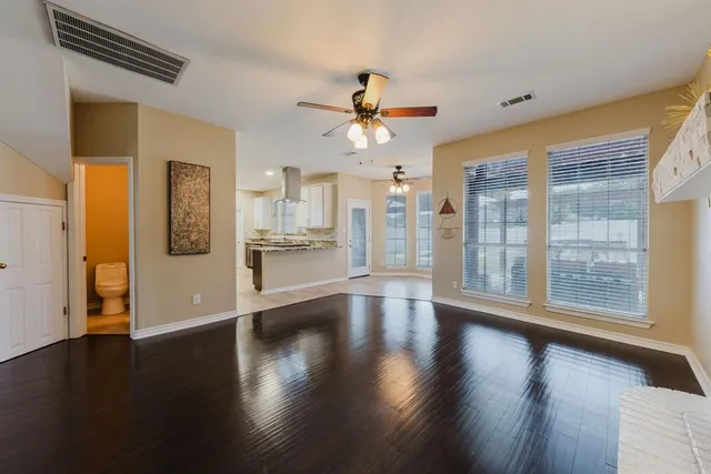 a kitchen with stainless steel appliances granite countertop a sink and a refrigerator
