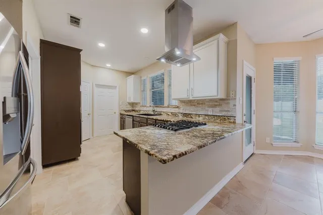 a kitchen with stainless steel appliances granite countertop a sink stove and cabinets