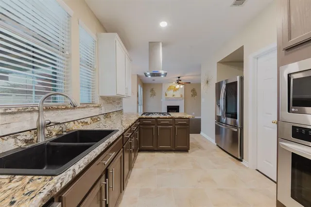 a kitchen with granite countertop stainless steel appliances and cabinets