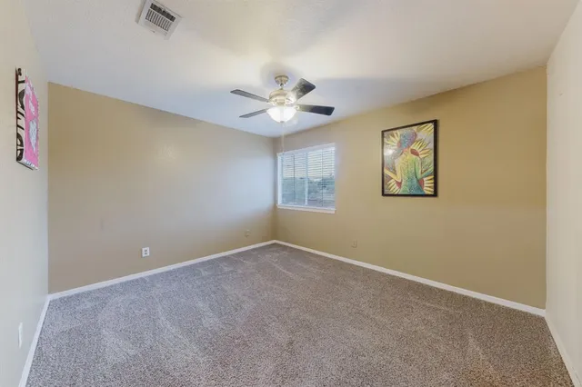 a view of room with window and ceiling fan