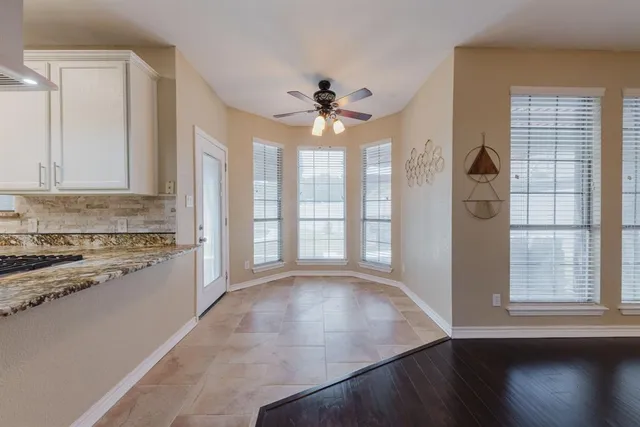 a spacious bathroom with a granite countertop sink and a mirror