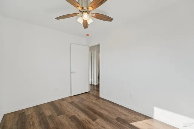 a view of a room with wooden floor and closet