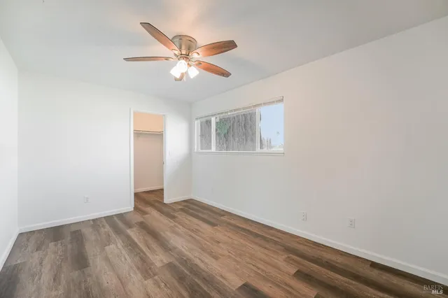 a view of a white house with a yard and plants