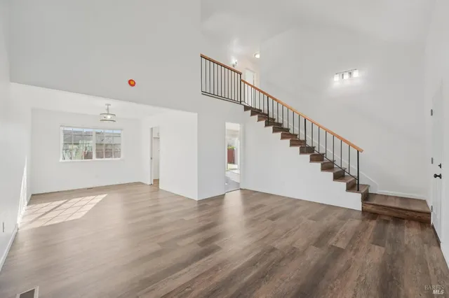 a view of a dining room with furniture a chandelier and wooden floor