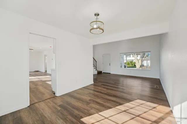 a living room with furniture a fireplace and a floor to ceiling window