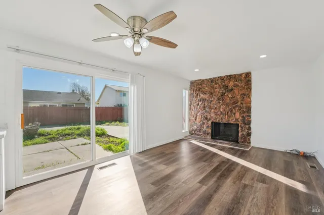 a kitchen with granite countertop white cabinets and stainless steel appliances