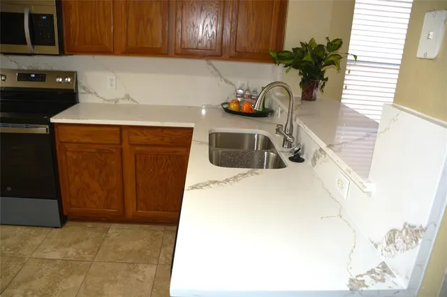 a kitchen with a sink and a stove