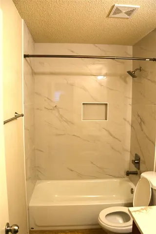 a bathroom with a shower and a toilet