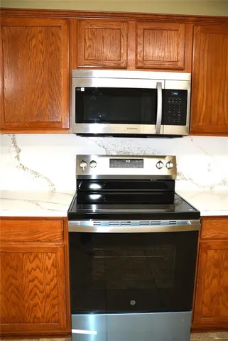a stove top oven sitting inside of a kitchen