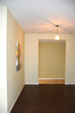 a view of a livingroom with wooden floor and a ceiling fan