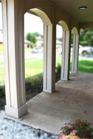 a stone house with yard and plants