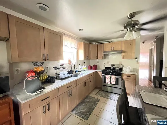 a kitchen with a sink a stove and cabinets
