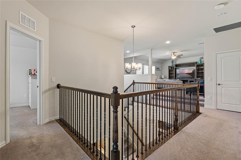 9517 Sunset Lane Oak Point, TX 75068 - Photo 30 of 40 9517 Sunset Lane, Oak Point, TX 75068 - hallway - upstairs hallway with an upstairs landing, carpet flooring, suspended lighting, and lofted ceiling