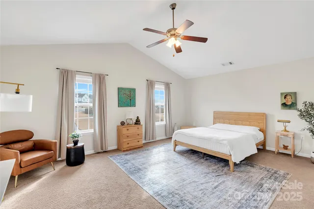 a bedroom with a bed and ceiling fan