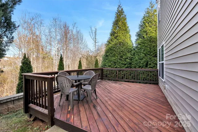 a view of a deck with wooden floor and outdoor seating