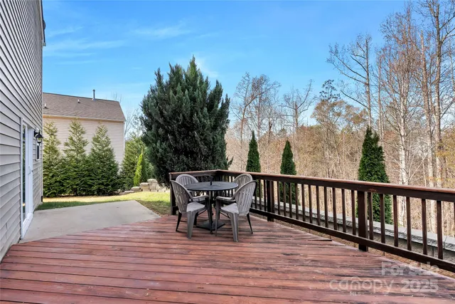 a view of a chairs and table on the wooden deck
