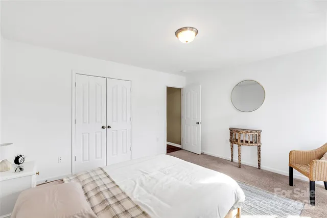 a bedroom with a bed and a lamp