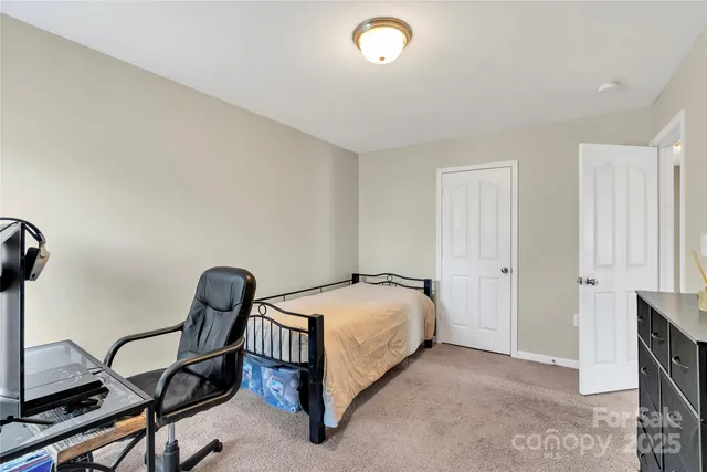 a bedroom with a bed and a chair
