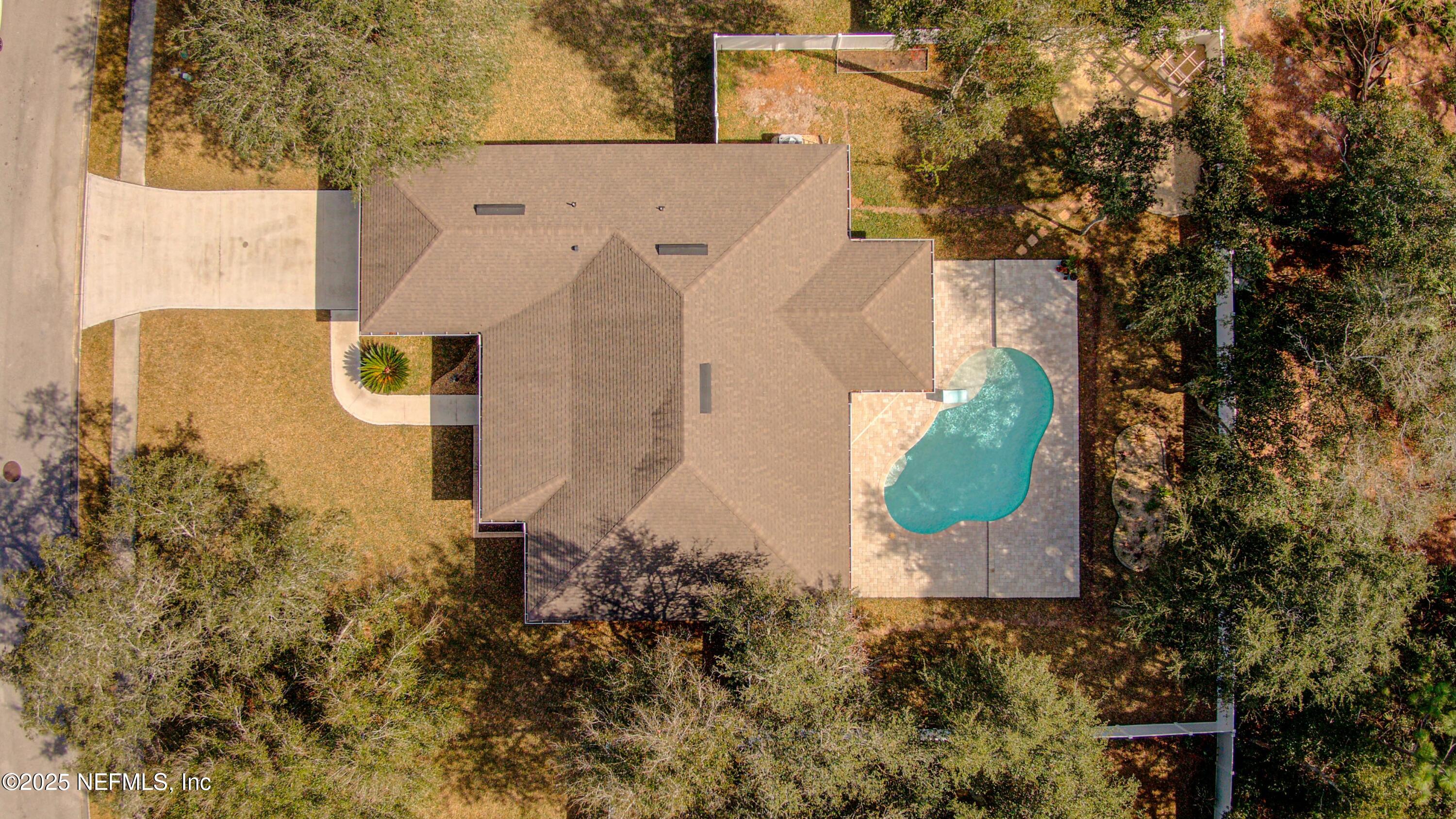 88083 Maybourne Road Yulee, FL 32097 - Photo 17 of 76 an aerial view of a house with a yard and garden