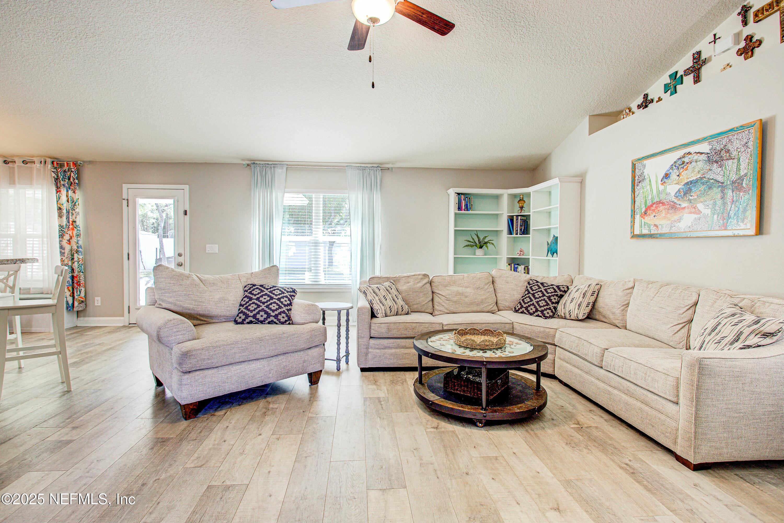 88083 Maybourne Road Yulee, FL 32097 - Photo 31 of 76 a living room with furniture and a large window