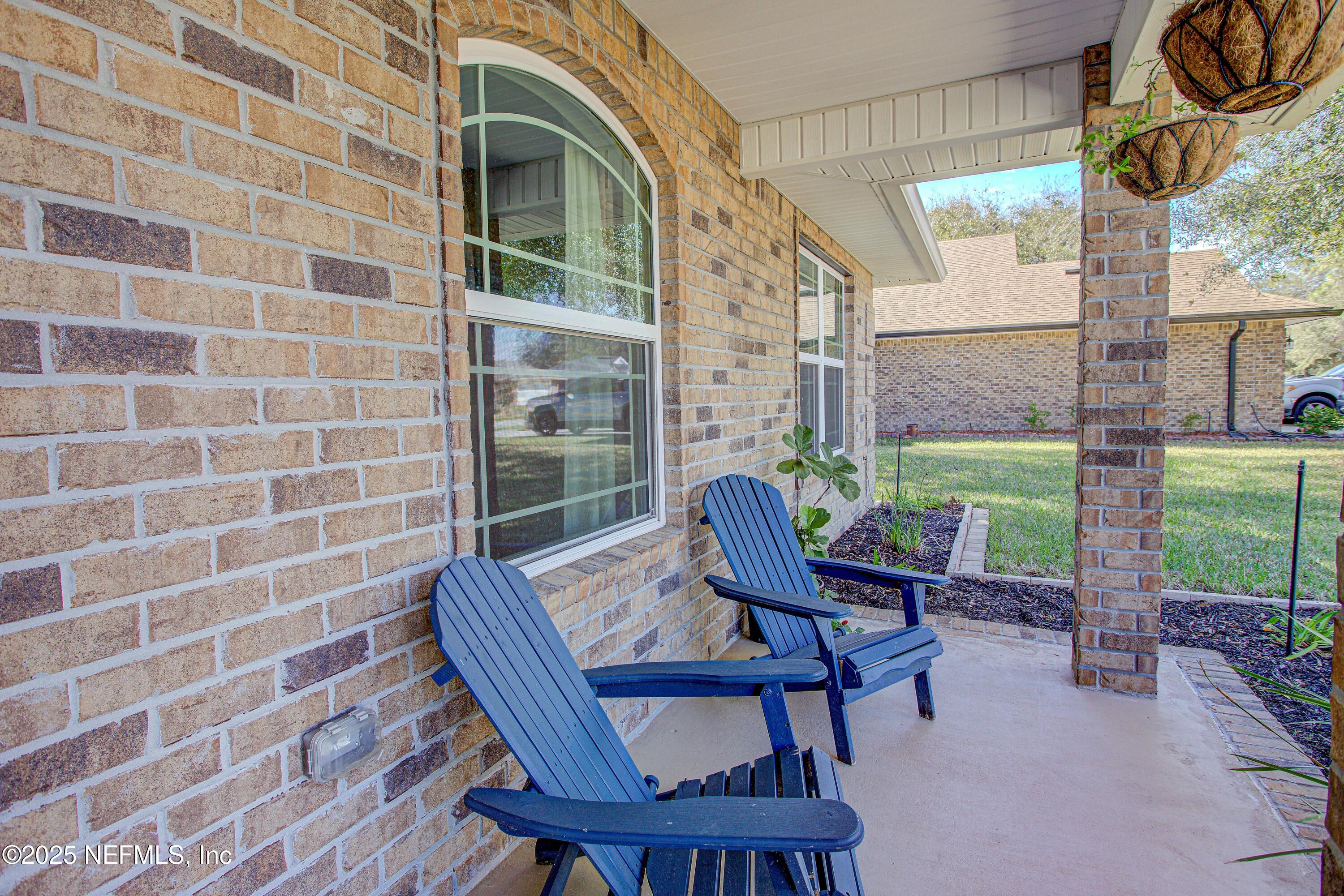 88083 Maybourne Road Yulee, FL 32097 - Photo 4 of 76 a view of a chair and table in the backyard