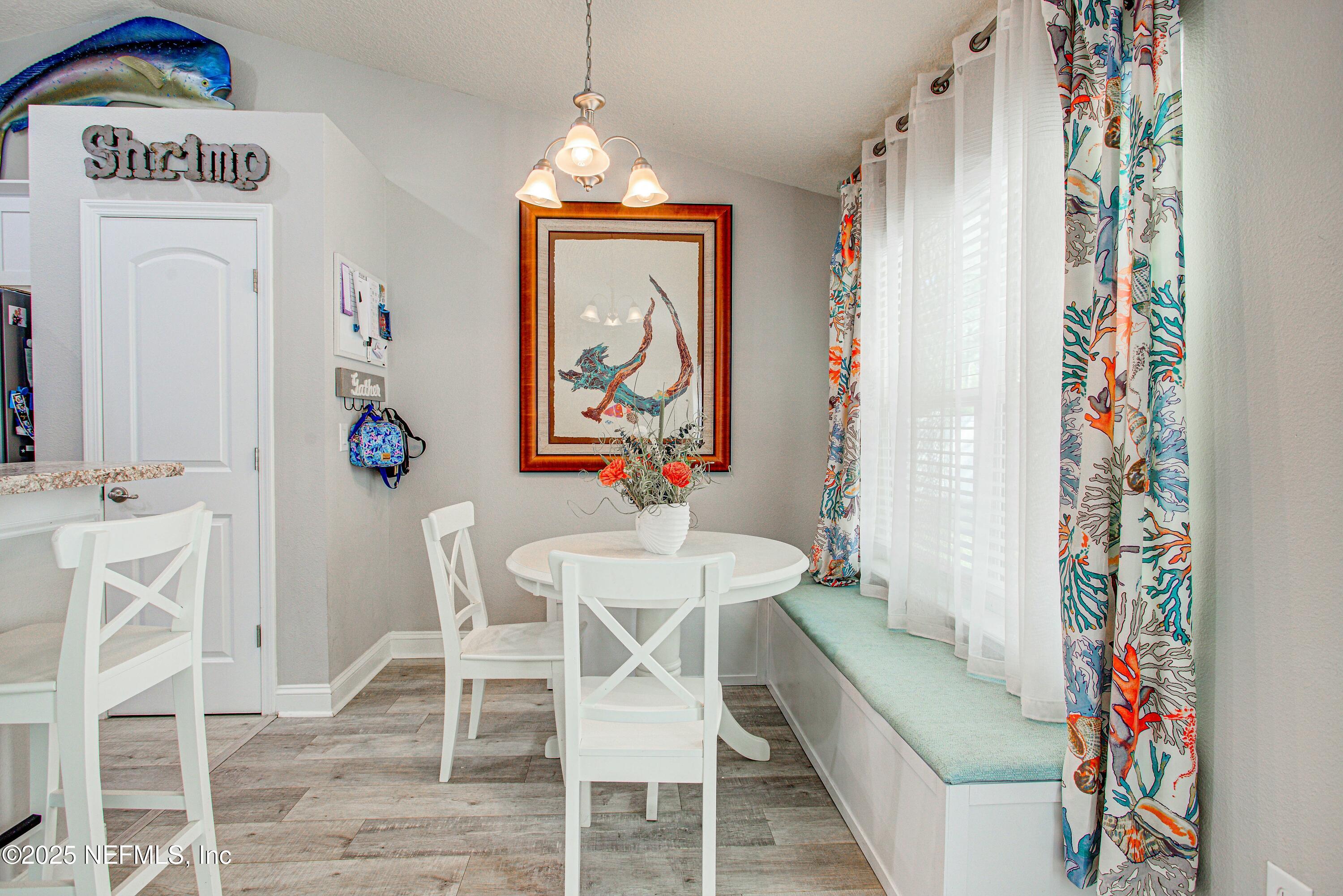 88083 Maybourne Road Yulee, FL 32097 - Photo 49 of 76 a view of a dining room with furniture window and wooden floor