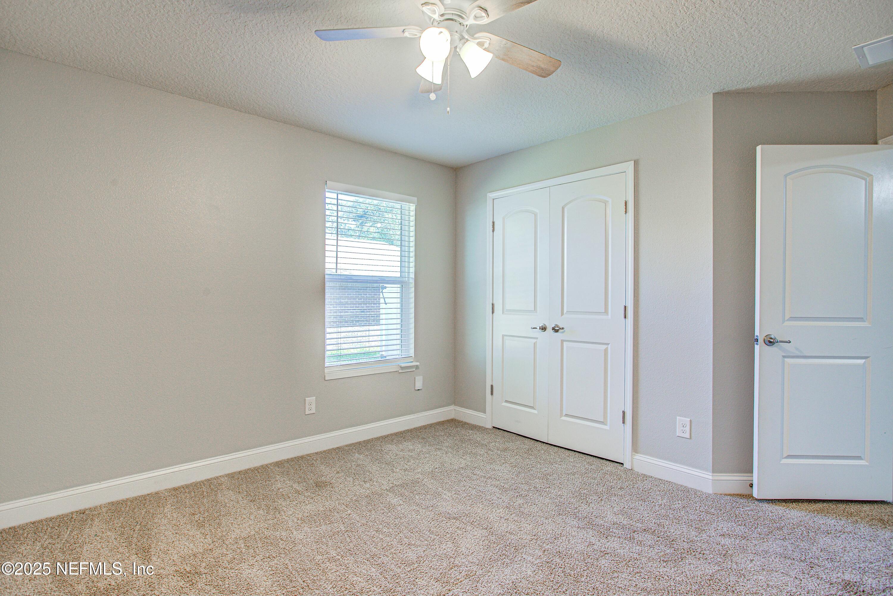 88083 Maybourne Road Yulee, FL 32097 - Photo 54 of 76 a view of an empty room with a window