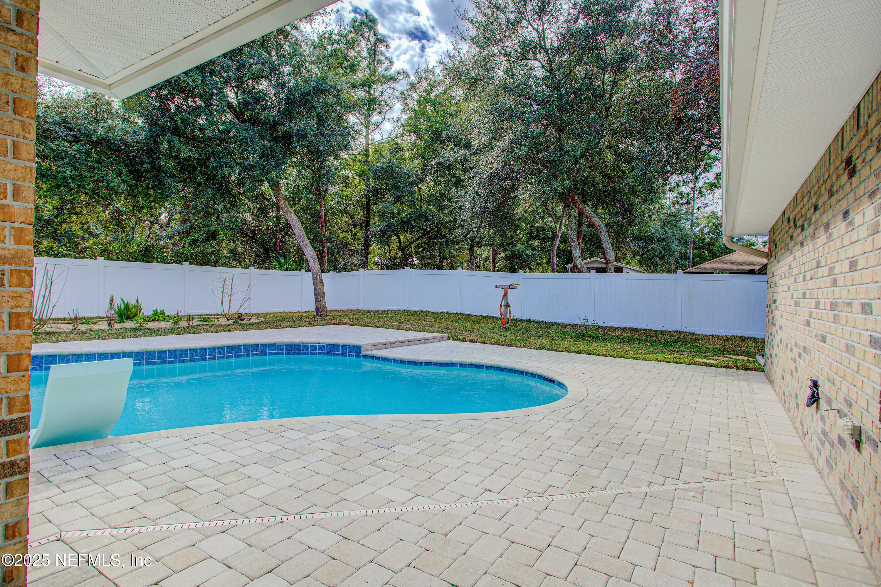 88083 Maybourne Road Yulee, FL 32097 - Photo 6 of 76 a view of a swimming pool with an outdoor space and seating area