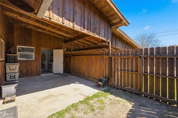 a view of backyard with tub and wooden fence