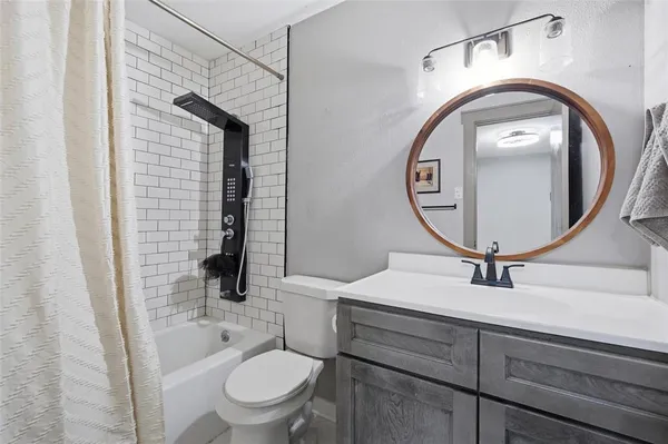 a bathroom with a toilet a sink and a mirror