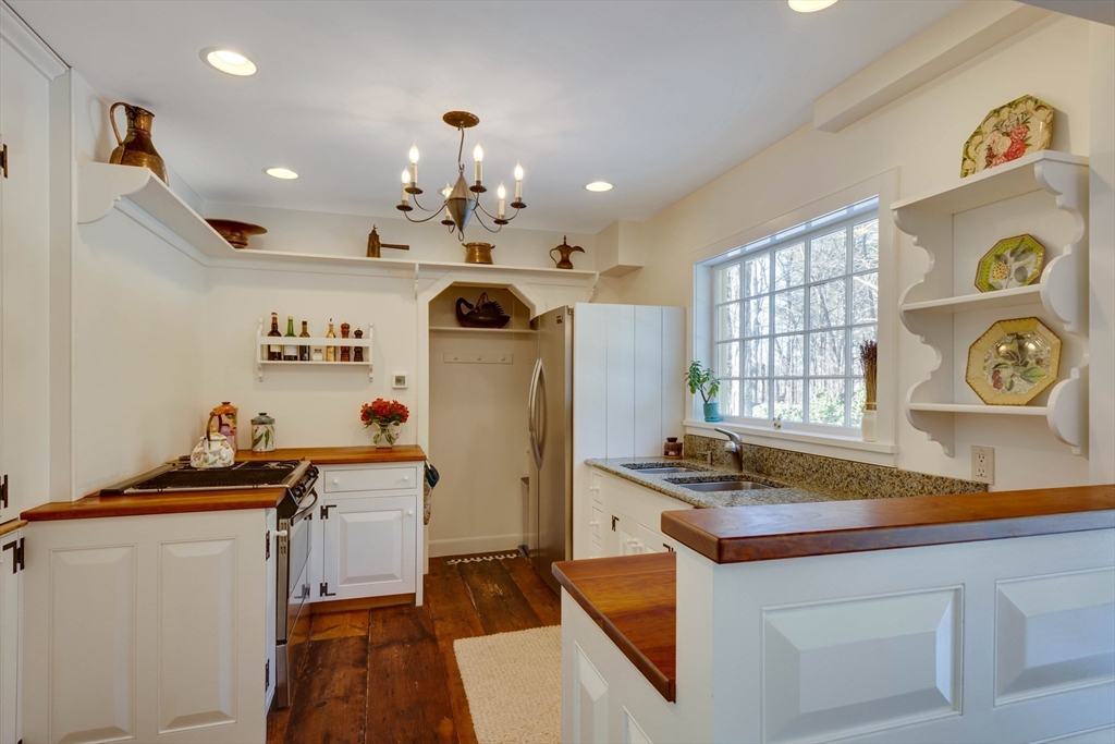 32 Pope Road Acton, MA 01720 - Photo 12 of 38 a kitchen with stainless steel appliances granite countertop a sink stove and refrigerator