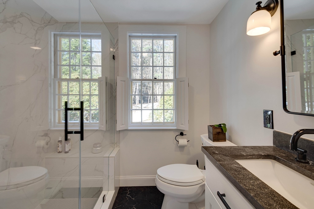 32 Pope Road Acton, MA 01720 - Photo 18 of 38 a bathroom with a granite countertop toilet sink and mirror