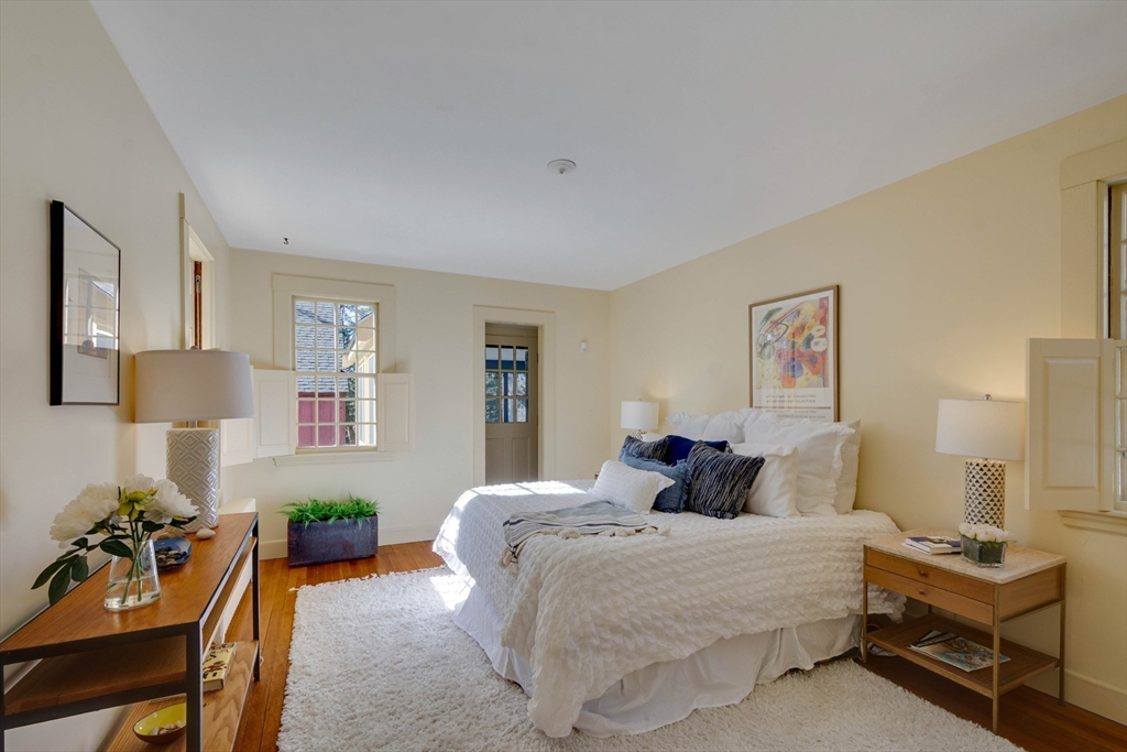 32 Pope Road Acton, MA 01720 - Photo 19 of 38 a bedroom with a bed and wooden floor