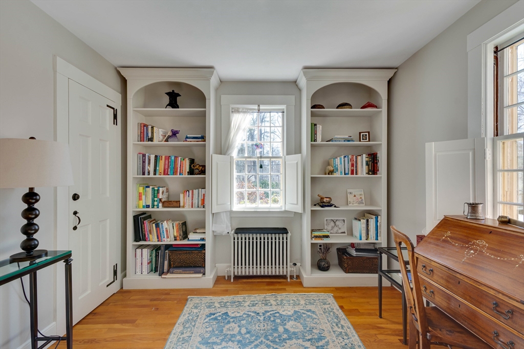 32 Pope Road Acton, MA 01720 - Photo 24 of 38 a bedroom with furniture and a book shelf