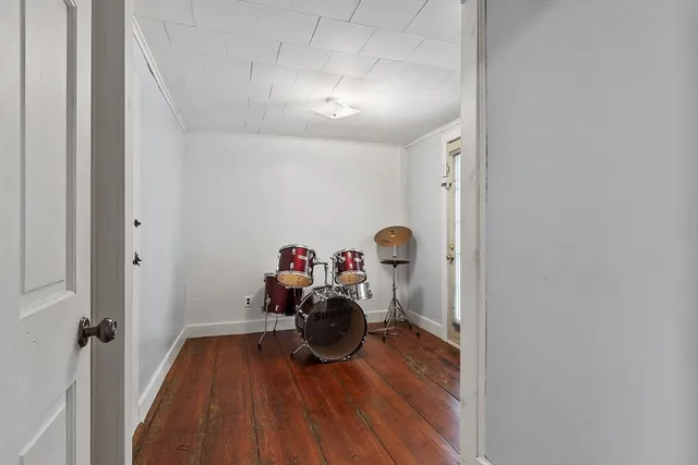 a living room with furniture a piano and a fireplace