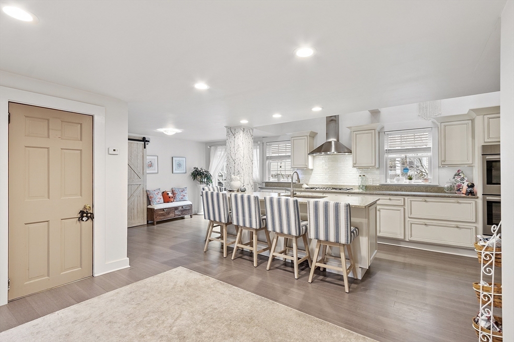 16 North Main Street West Boylston, MA 01583 - Photo 4 of 41 a kitchen with white cabinets and chairs