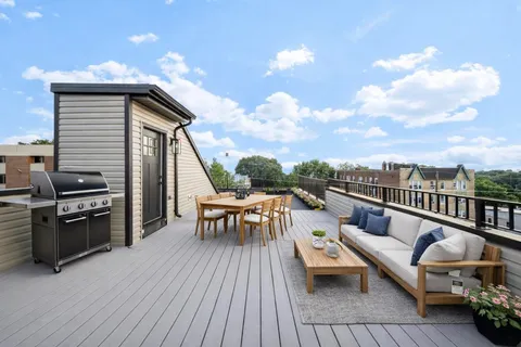 a view of a roof deck with couches