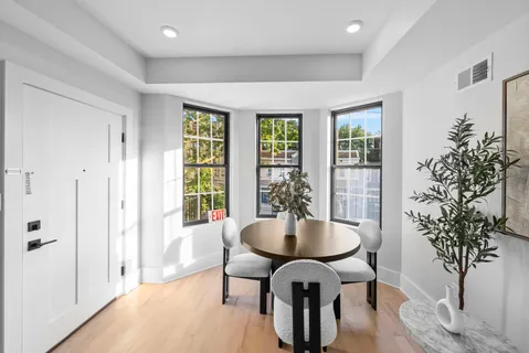 a view of a dining room with furniture window and wooden floor