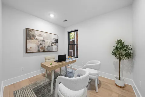 a living room with furniture and a potted plant