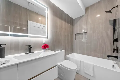 a bathroom with a sink toilet tub and shower