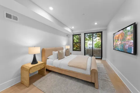 a bedroom with a bed and lamp