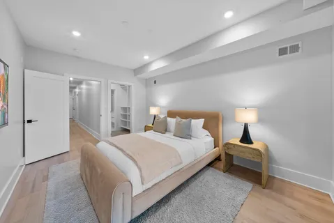 a bedroom with a bed and a lamp