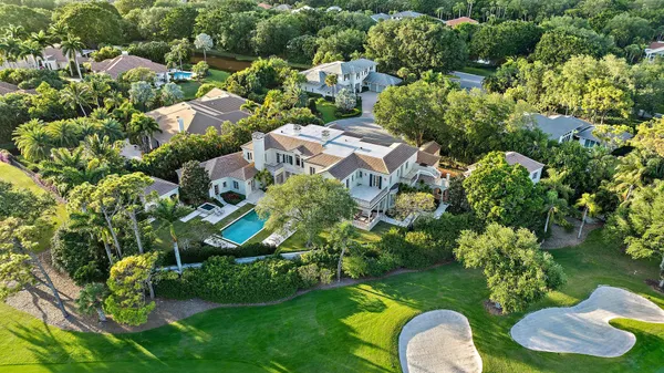 an aerial view of a house with yard swimming pool and outdoor seating