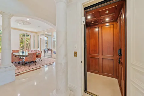 a living room with furniture large window and flat screen tv