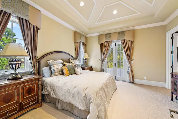 a living room with furniture a flat screen tv and a large window