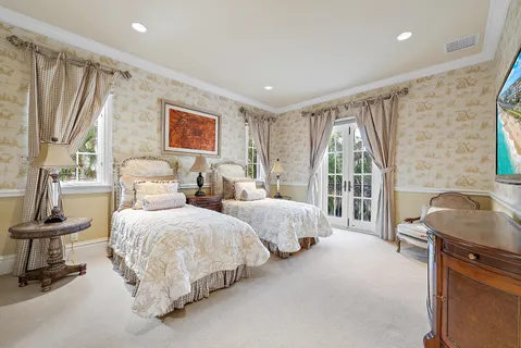 a view of empty room with wooden floor and kitchen