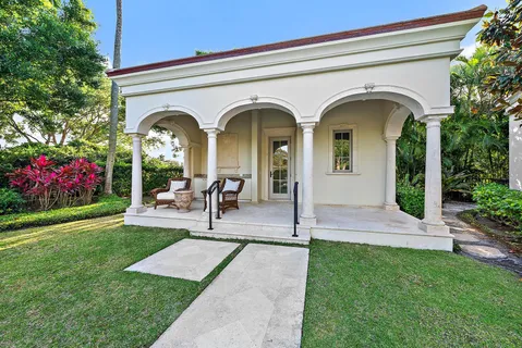 a view of an house with swimming pool and sitting area